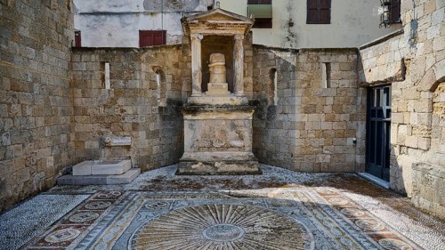 Doric columns at a historical site, temple pediment, sculpture with snake, detailed mosaic on the