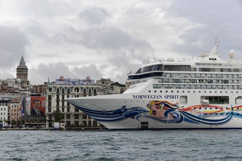 Close-up of the cruise ship 'Norwegian Spirit' in front of the silhouette of the Galata Tower,