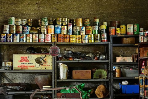 Historic garage on Route 66 with grease and oil cans in the frame, USA, North America