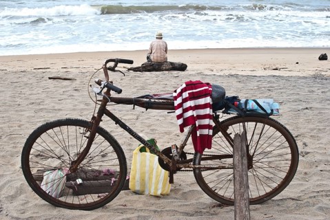 Old man fishing on the beach, looking the Indian ocean, Mananjary, Madagascar. In the foreground,
