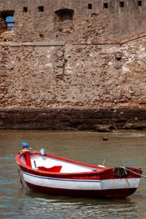 Small fishing boat anchored in front of the historic city wall in Cadiz, Andalusia, Spain, Europe