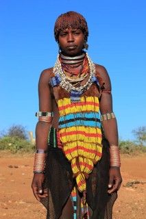 South Ethiopia, Omo region, young woman of the Hammer people, wears a lot of jewellery and her hair