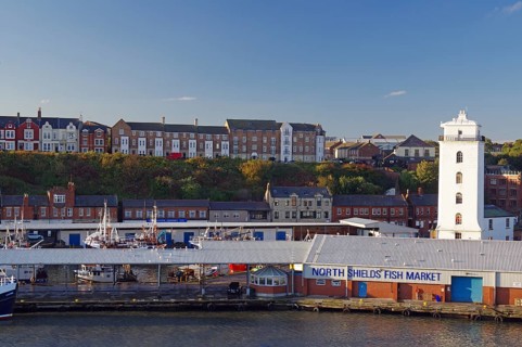 Residential houses, lighthouse and old warehouses at the harbour of Tynemouth, ferry trip Amsterdam