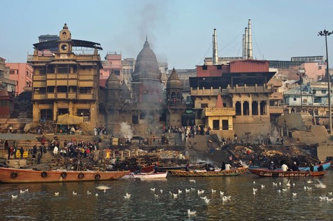 Manikarnika ghat, the main cremation ground in Varanasi, India. Ganges river and gulls in the