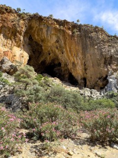View of large natural grotto cave in Agiofarago Gorge of the Saints on south coast of island of