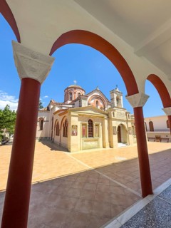 View through archway to main entrance portal of orthodox church monastery church Zoodochos Pege in