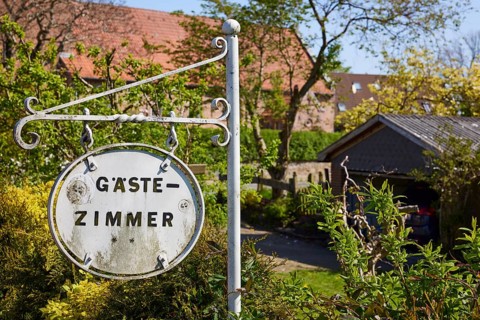 Old sign for guest rooms in Niebuell, district of Nordfriesland, Schleswig-Holstein, Germany,