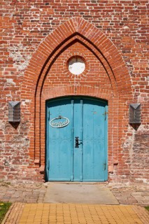 Entrance door to St Laurentius Church in Toenning, North Friesland district, Schleswig-Holstein,