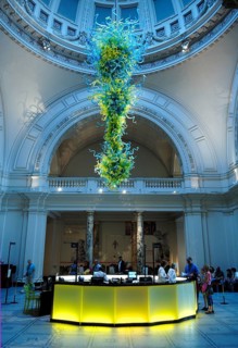 Artistic glass object under the dome in the reception hall with information stand of the Victoria &