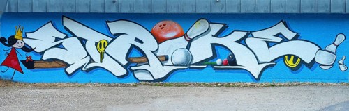 Large graffiti on a wall with the word 'strike' surrounded by colourful elements, painting of the