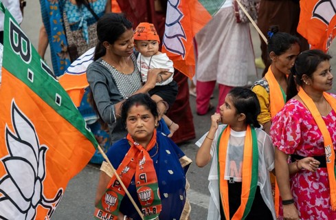 Bharatiya Janata Party (BJP) supporters arrives to to see a roadshow of Union Home minister Amit