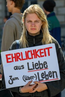Participant in a silent demonstration for the hunger strikers. Her poster reads Honesty for the