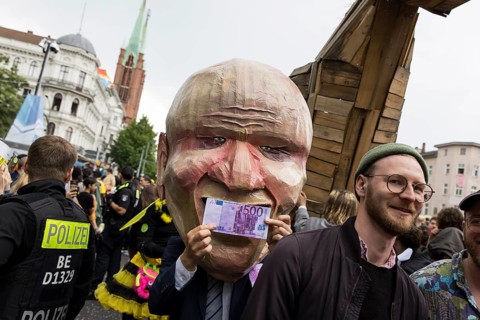 Dancer dressed as an investor from the 100% Tempelhofer Feld group at the street parade of the 26th