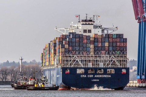 A container ship of the CMA CGM shipping company is brought to Burchardkai in the Port of Hamburg