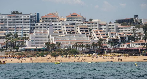 Coast with beach and hotels, people relaxing under parasols Albufeira, Algarve, Portugal, Europe