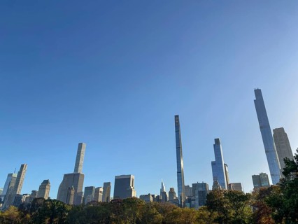 Cityscape with towering skyscrapers and autumnal trees in central park, the skyline of new york