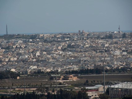 City view with many white and grey houses, sea in the background, urban ambience, the town of mdina
