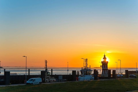 Pingelturm, historic lighthouse in the harbour, atmospheric, golden, beautiful sunset, silhouette
