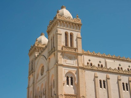 Historic church with impressive architecture and domes under a clear sky, Tunis in Africa with