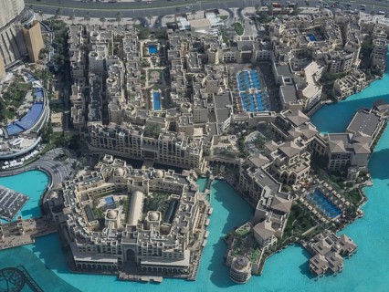 Luxury hotel complexes with several swimming pools and turquoise-coloured water, presented in