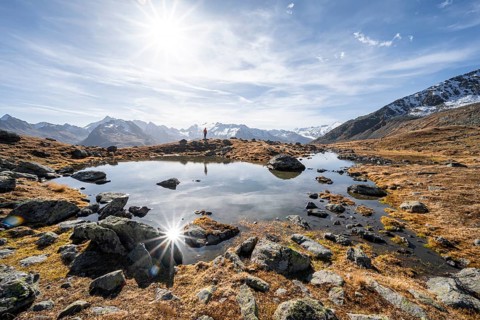 Mountaineers at a small lake on the high plateau of the Gurgler Seenplatte, glaciated mountain