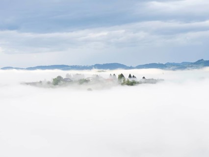Morning fog over the village of Frauenberg, view from Silberberg, near Leibnitz, Styria, Austria,