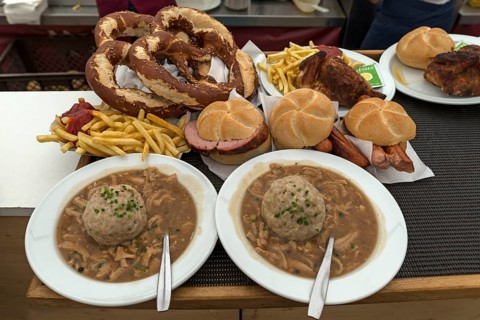 Tray with ordered marquee food, pretzels, baked Haendel, soup with liver dumplings,