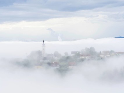 Church rises out of the morning mist, Frauenberg pilgrimage church, near Leibnitz, Styria, Austria,