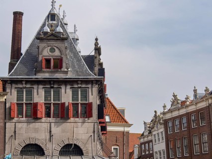 Historic building with gabled roof and red shutters in an old town, historic houses in Hoorn and