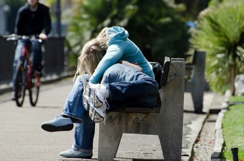 Couple Sleeping on a Bench and One on Bicycle in a Sunny Day on Walkway in Switzerland