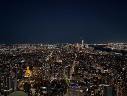 Night view of an illuminated skyline of a big city with countless skyscrapers under a clear sky,