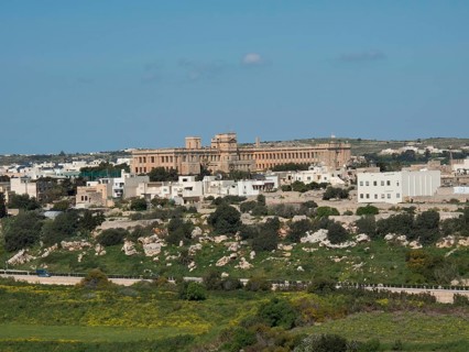 Town view with historic buildings on a hill, lots of greenery, traditional ambience, the town of