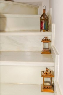 Various lanterns placed on the steps of a marble staircase