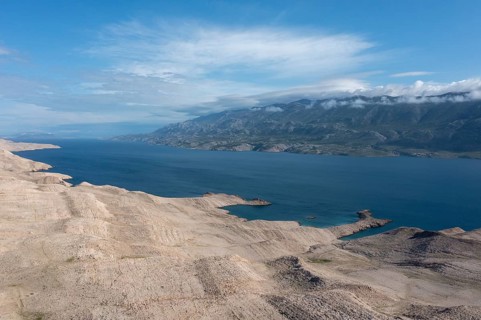 Lunar landscape, coast of the island of Pag, view of the mainland and the Velebit mountains, Zadar,