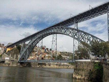 Large iron bridge crossing a river with a neighbourhood in the background, the atlstadt panorama of