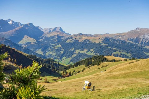 A picturesque mountain landscape with green hills and a blue sky in the sunshine, mountain panorama