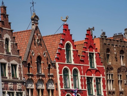 Colourful historic buildings with ornate facades and gables under a blue sky, historic house