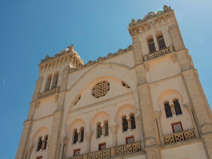 Front view of a large historic building with domes and beautiful decorations, Tunis in Africa with