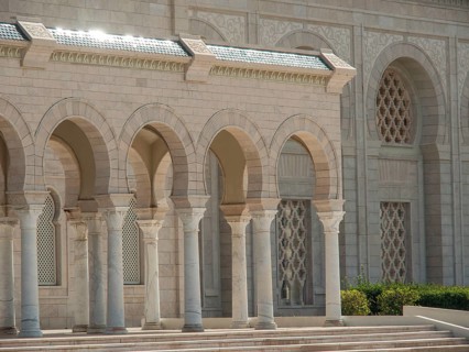 A monumental building with large stone arcades shining in the sunlight, Tunis in Africa with ruins