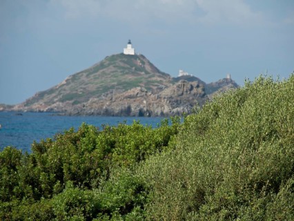 Lighthouse on a hilly, rocky cape overlooking the sea, Corsica, ajaccio, France, Europe