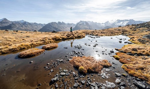 Mountaineers at a small lake on the high plateau of the Gurgler Seenplatte, glaciated mountain