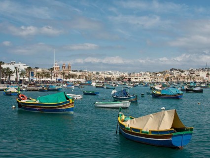Panorama of a coastal town with colourful boats on the sea and clear sky, colourful boats in a