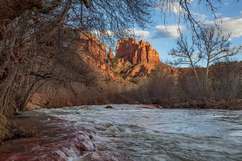 Cathedral Rock sandstone formations tower over Oak Creek at the Crescent Moon Picnic Site in