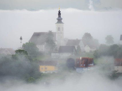 Church rises out of the morning mist, Frauenberg pilgrimage church, near Leibnitz, Styria, Austria,