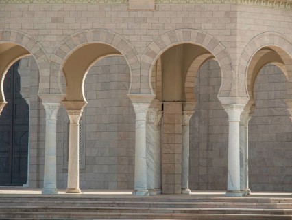 Stone columns and open arcades of an ancient building with stone steps, Tunis in Africa with ruins