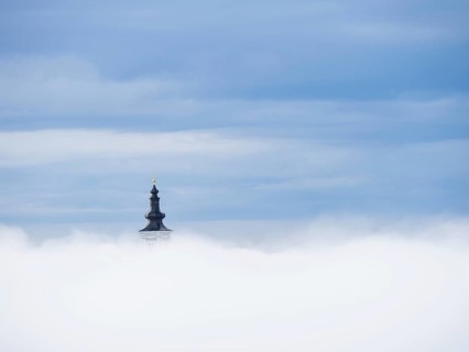 Church tower rises out of the morning mist, Frauenberg pilgrimage church, near Leibnitz, Styria,