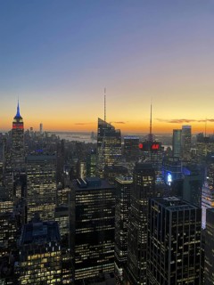 Cityscape at dusk with the Empire State Building and other illuminated skyscrapers, the skyline of