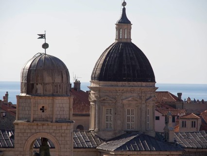 Historic towers and domes against a backdrop of roofscape and sea, the old town of Dubrovnik with