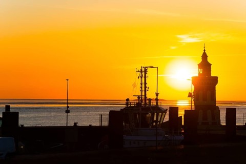 Pingelturm, historic lighthouse in the harbour, atmospheric, golden, beautiful sunset, silhouette