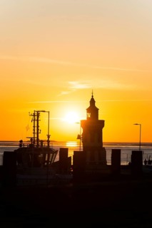 Pingelturm, historic lighthouse in the harbour, atmospheric, golden, beautiful sunset, silhouette